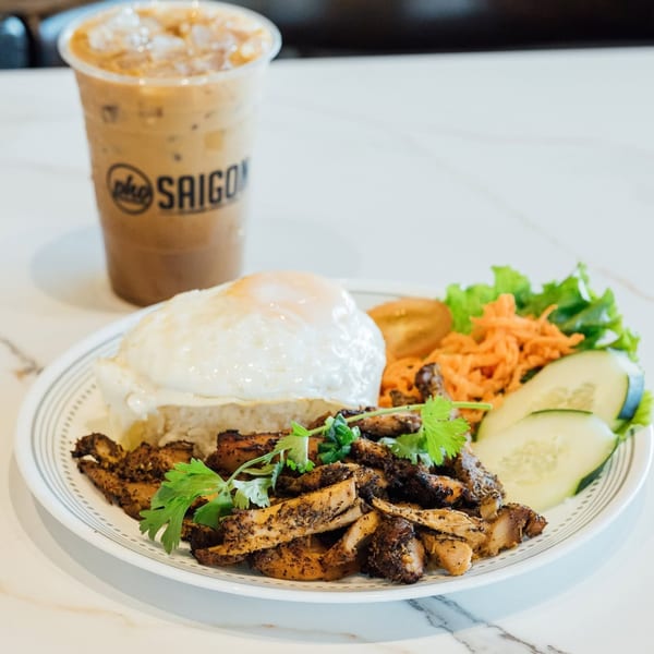 Pho Saigon's grilled chicken rice plate with fried egg, salad, and iced coffee.