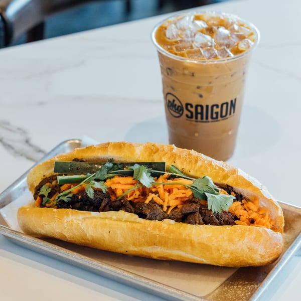 Banh mi sandwich with beef, carrots, cucumber, cilantro, and Pho Saigon iced coffee.